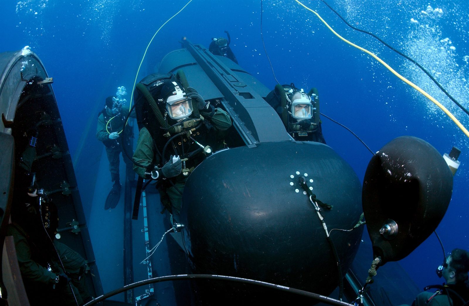 Navy divers deploying a SEAL Delivery Vehicle from a submarine